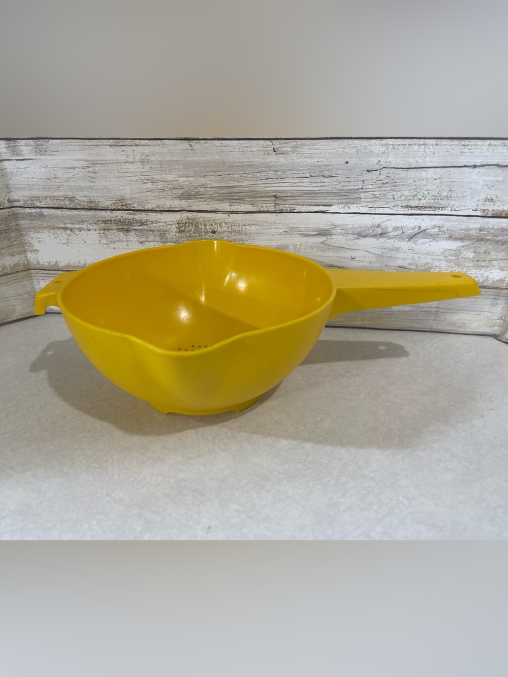 Large yellow vintage Tupperware strainer